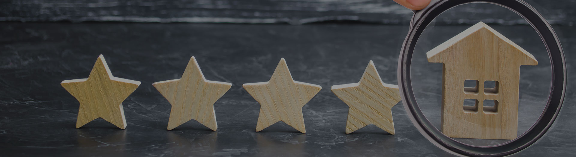 four wooden stars and one wooden house